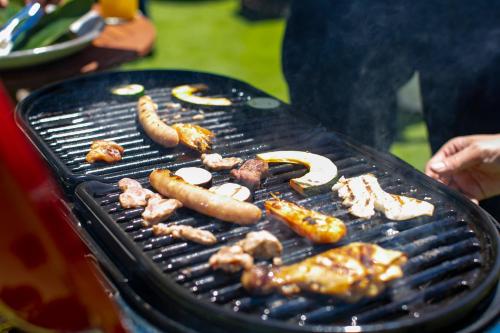 a grill with sausage and other food on it at Sendai Royal Park Hotel in Sendai