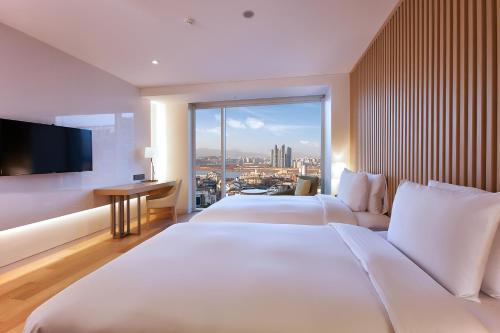 a hotel room with two beds and a large window at Hotel Entra Gangnam in Seoul