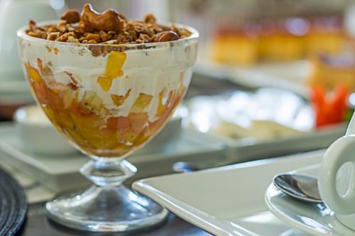 a glass bowl filled with ice cream and nuts at Pousada Calypso in Trancoso