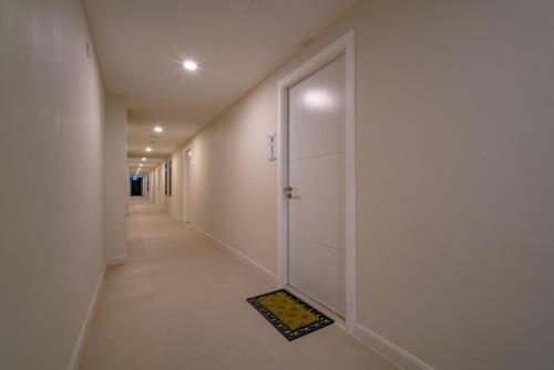 a hallway with a door with a drain in the floor at Babylon Sky Garden - Long Term Holiday Rentals in Rawai Beach