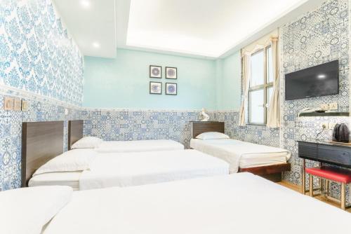Postel nebo postele na pokoji v ubytování Hou Kong Hotel