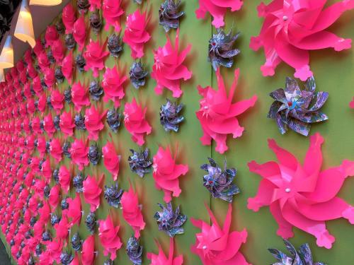 a display of pink flowers on a green wall at HOTEL TAVINOS Asakusa in Tokyo