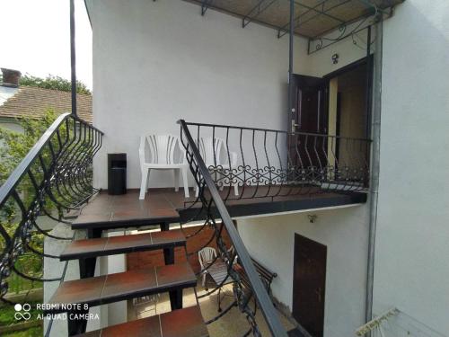 a balcony of a house with a stair railing at Sadyba Margaryta in Truskavets