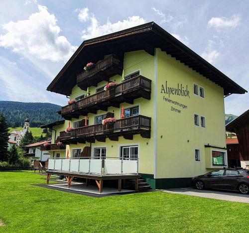 a large building with balconies on the side of it at B&B Gästehaus Alpenblick in Lermoos