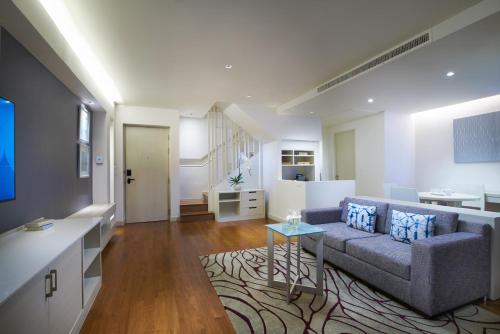 a living room with a couch and a table at Amari Pattaya in Pattaya Central
