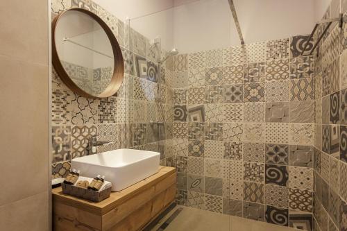 a bathroom with a sink and a mirror at White Vama Veche in Vama Veche