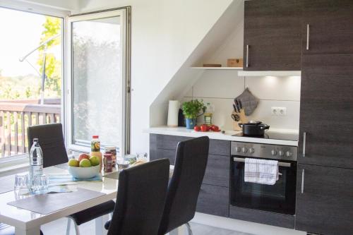 a kitchen with a dining table and a stove at FeWo Maschblick in Schwarmstedt