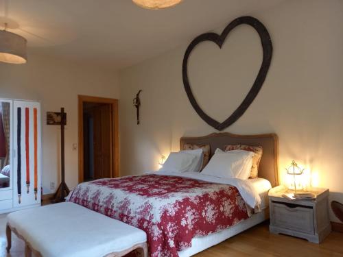 a bedroom with a bed with a heart on the wall at la Tour d'Héloïse - 10' de Bruxelles in La Hulpe