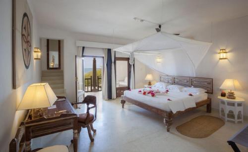 a bedroom with a large bed with flowers on it at The Majlis Resort in Lamu