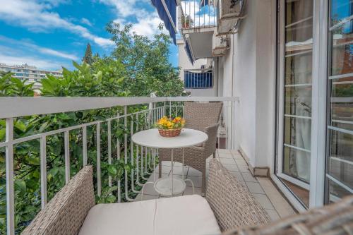 a balcony with a table and chairs on a building at Marinero Apartments in Budva