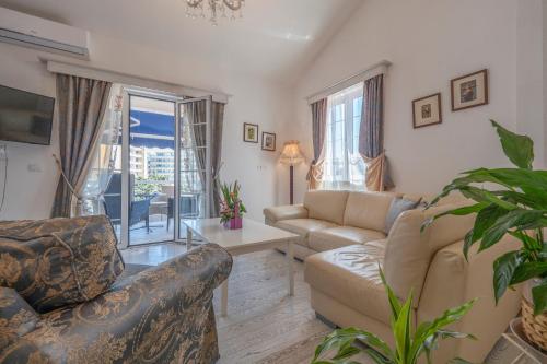 a living room with a couch and a table at Marinero Apartments in Budva