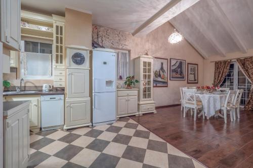 a kitchen with a table and a white refrigerator at Marinero Apartments in Budva