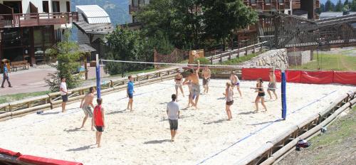 a group of people playing volleyball in the sand at Résidence Saboia B13 Clés Blanches Courchevel in Courchevel