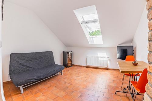 a room with a bed and a table and a tv at Žabinec - penzion, vinotéka in Kurdějov