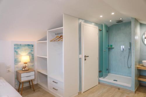 a bedroom with a shower and a white closet at Georgia Villas in Skiathos