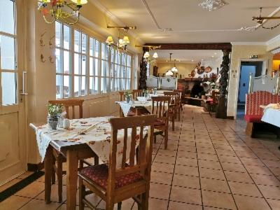 a dining room with tables and chairs in a restaurant at Hotel Meyer in Kürten