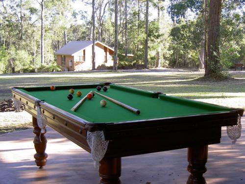 a pool table with balls on top of it at Bewong River Retreat in Bewong