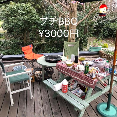 a picnic table and chairs on a deck at ガーデンハウス Mako Land in Toyama