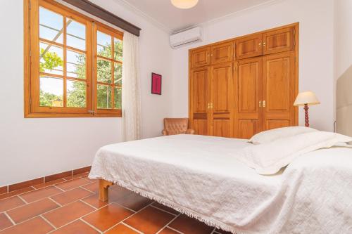 a bedroom with a bed and a window at Can Moscari in Inca