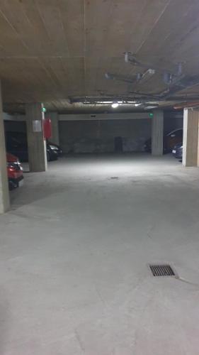 an empty parking garage with cars parked in it at Apartman Sweet dreams 2 in Niš