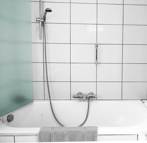 a shower in a bathroom with a bath tub at Apartments Ypres in Ypres