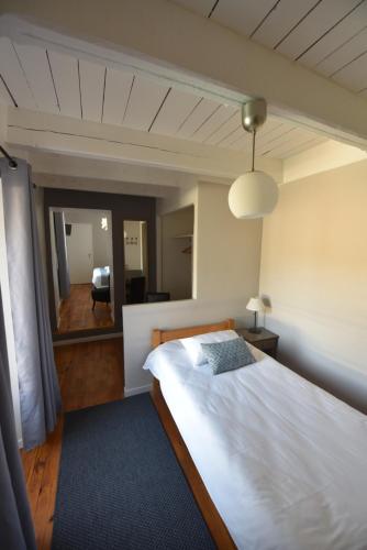 a bedroom with a large bed and a mirror at Hotel Restaurant La Calade in Octon