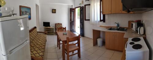 a kitchen with a table and a counter top at Nikos and Eva Studios in Symi