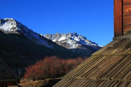 a view of a snow covered mountain from a house at Le Miou hameau des Chazals Nevache Hautes Alpes in Névache
