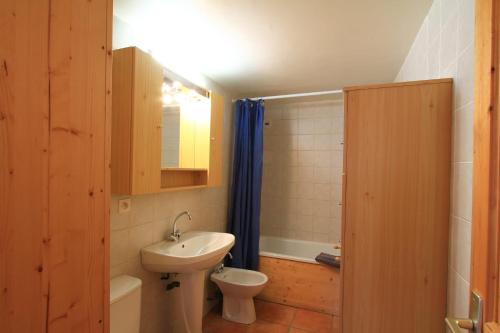 a small bathroom with a sink and a toilet at Le Miou hameau des Chazals Nevache Hautes Alpes in Névache