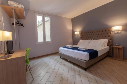 Ένα ή περισσότερα κρεβάτια σε δωμάτιο στο Hotel Genziana