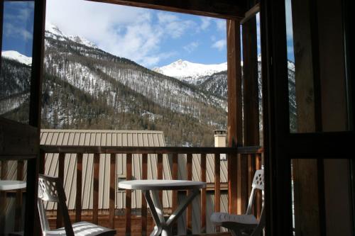a view of a snowy mountain from a window at Le Queyrellin hameau des Chazals Nevache Hautes Alpes in Névache