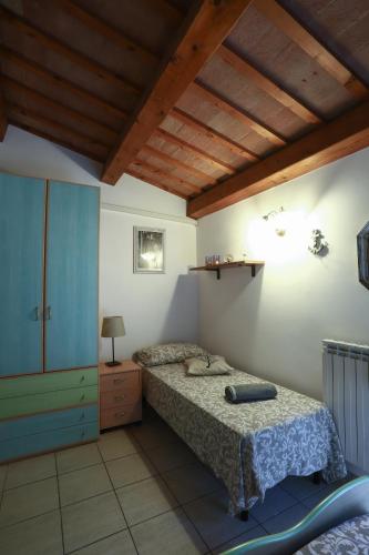 a bedroom with a bed and a wooden ceiling at A Casa di Claudia in Loreto