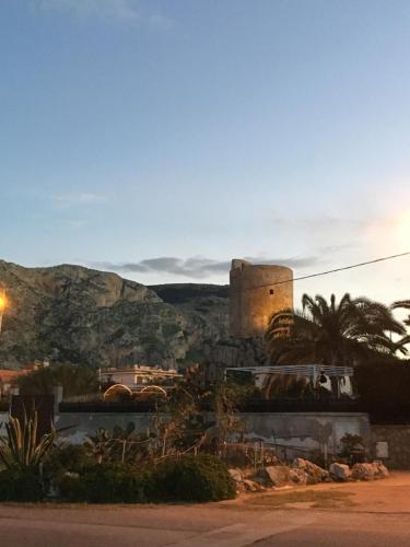 a view of a city with a castle in the distance at Casa Vacanza La Isla Bonita in Isola delle Femmine