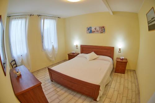 a bedroom with a large bed and two night stands at Agriturismo Da Rosy in Codevigo
