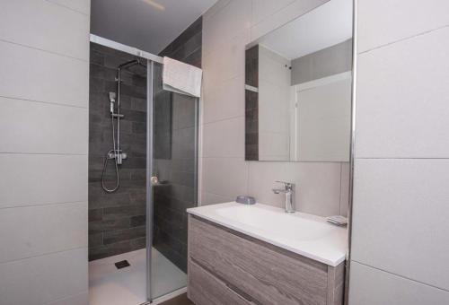 a bathroom with a sink and a shower at APARTAMENTOS LLAMIEVA in Posada de Llanes