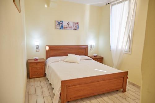 a bedroom with a bed and two night stands and a window at Agriturismo Da Rosy in Codevigo