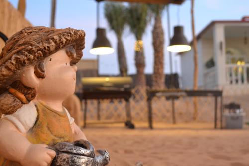 a statue of a girl with a hat on her head at Farm Lebanon in Abu Dhabi