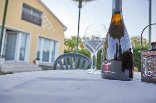 a bottle of wine sitting on a table with a glass at Agriturismo Da Rosy in Codevigo