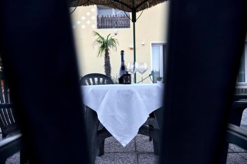 a table with a bottle of wine and two glasses at Agriturismo Da Rosy in Codevigo