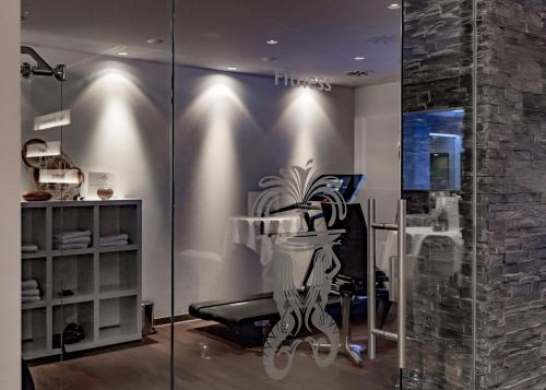 a glass room with a chair and a desk at Schlosshotel Kassel in Kassel