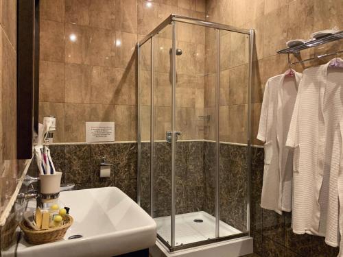 a bathroom with a tub, toilet and shower stall at Avshar Hotel Resort in Krasnogorsk