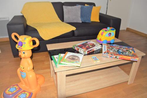 a living room with a table with a toy dog on it at Dream Appartement Paris in Montévrain