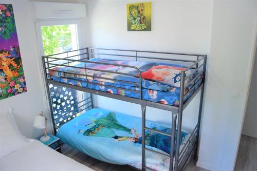 a bunk bed with two bunk beds in a room at Dream Appartement Paris in Montévrain