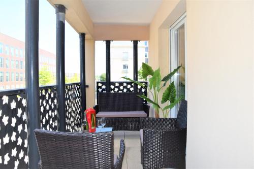 a balcony with chairs and a plant on it at Dream Appartement Paris in Montévrain