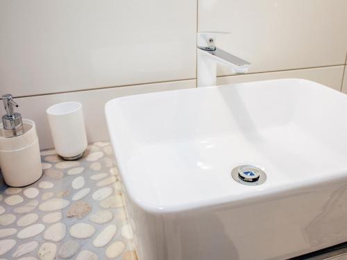 a bathroom with a white toilet with a sink at Kaszubskie Zacisze in Władysławowo