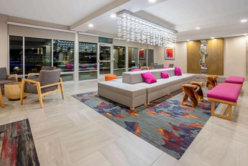 a living room with a couch and a rug at La Quinta by Wyndham Seattle Federal Way in Federal Way