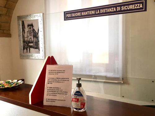 a bottle of cleaner sitting on a table with a sign at Antico Borgo Chieti in Chieti