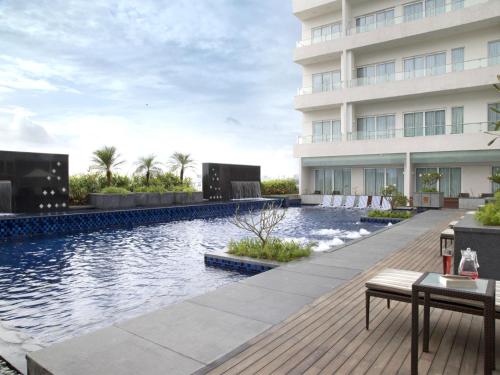 a swimming pool in front of a building at Oakwood Residence Whitefield Bangalore in Bengaluru