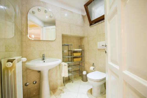 a bathroom with a sink and a toilet and a mirror at Giulia in Verbania