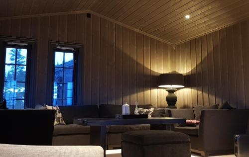 a living room with a couch and a table at Mjøshytte in Stange